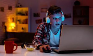 Teen Boy Gambling On Laptop