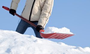 Man shoveling snow in winter.
