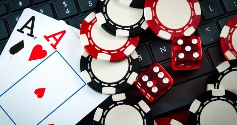 cards, chips, and dice on keyboard