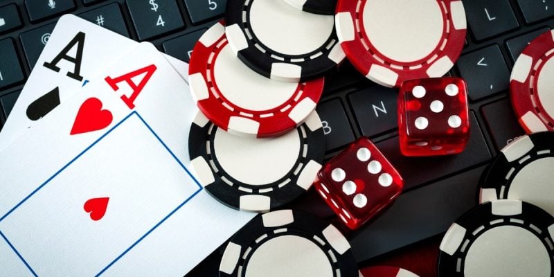 cards, chips, and dice on keyboard