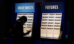 Customer Looks Over Daily Sheets Inside FanDuel Sportsbook