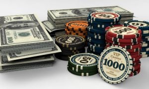Stacked Cash Next To Poker Chips