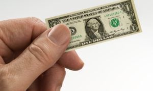 hand holding small paper bill