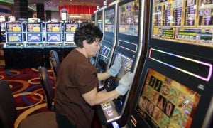 person cleaning slot machines