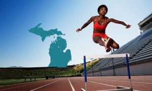 person jumping track hurdle