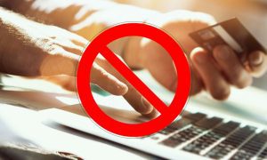 Banned Symbol Over Man Paying Online With CC