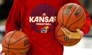 Kansas Team Manager Carries Basketballs
