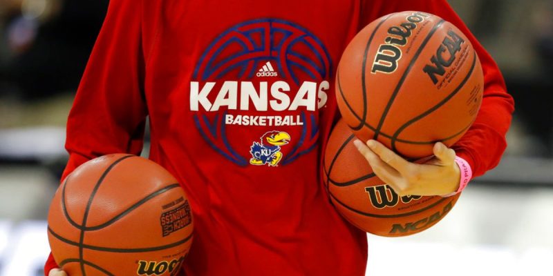 Kansas Team Manager Carries Basketballs