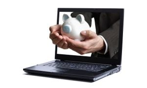 Man's Hands Presents Piggy Bank In Laptop