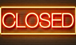 closed neon sign on wall