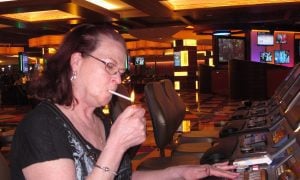 person lights up cigarette