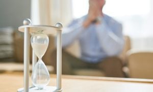 sands falling through hourglass