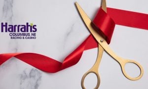 gold scissors cutting red ribbon