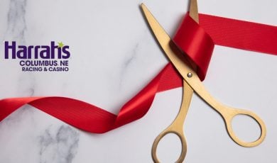 gold scissors cutting red ribbon