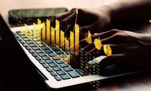 Hands On Laptop With Financial Graph Overlay