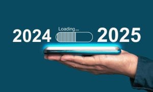 Hand Holds Cell Phone With 2025 Loading