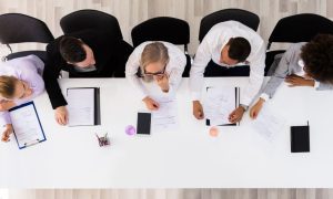 Aerial View Professionals Sit At Table Meeting