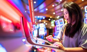 Asian Lady Excited At Casino Slot Machine