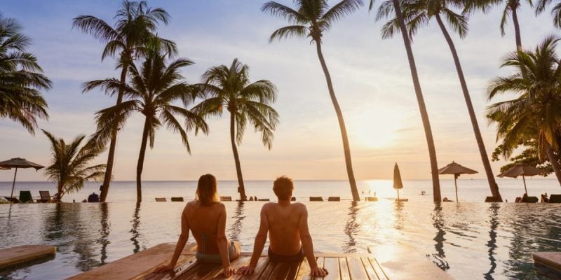 Couple Watches Sunset On The Beach