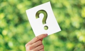 Hand Holds Paper With Transparent Question Mark