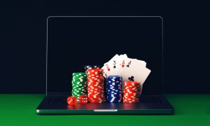 Laptop With Casino Chips And Playing Cards