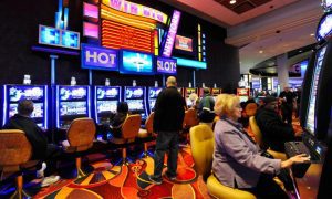 Visitors Play Slot Machines At Resorts World Casino