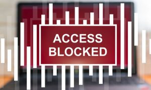 Blurred Laptop Backgroud With Access Blocked Verbiage Overlay