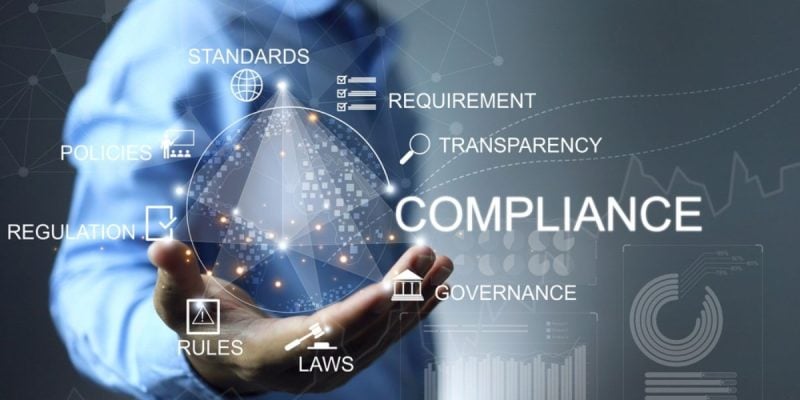 Business Man Holds Hand Out With Digital Sphere Compliance Concept