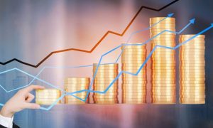 Gold Stacked Coins With Line Graph Overlay And Man's Hand