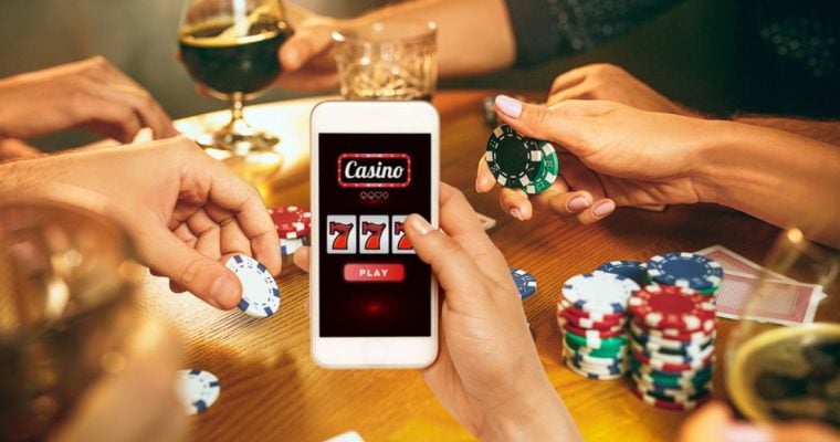Man Holds Cell Phone Displaying Online Casino