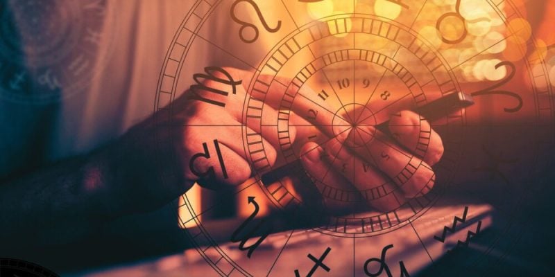 Man Holds Cell Phone With Astrology Symbols Foreground
