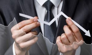 Man In Suit Holds Downward Pointing Arrow