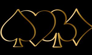 Playing Cards Suits Symbols In Gold On Black Background.jpg