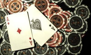 Two Aces Lay On Red And Black Poker Chips