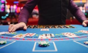 A blackjack dealer taking bets
