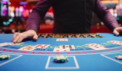A blackjack dealer taking bets
