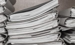 stacks of documents in binders