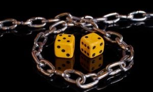 a pair of dice surrounded by a chain