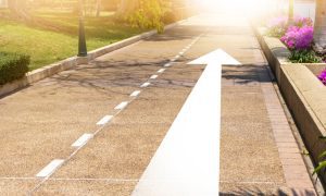 a road with an arrow pointing upward