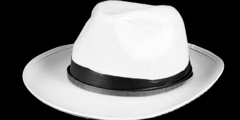 a white hat on a black canvas