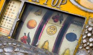Mechanical reels of a vintage Rol-a-Top slot machine, showing corrosion