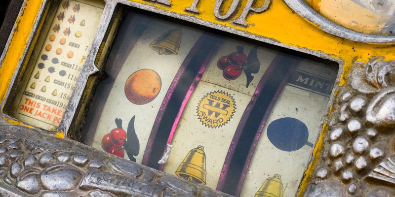 Mechanical reels of a vintage Rol-a-Top slot machine, showing corrosion