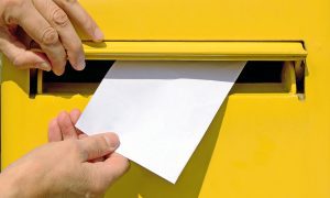 Postage person mailing letter yellow mailbox