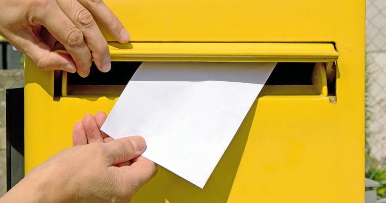 Postage person mailing letter yellow mailbox