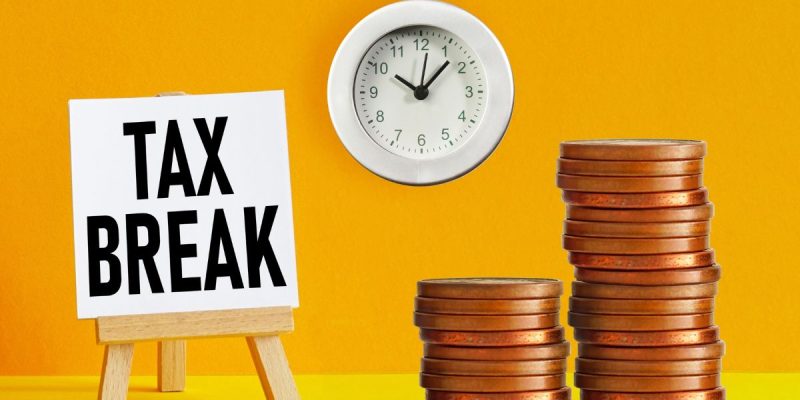 a stack of coins and a clock next to a sign reading 