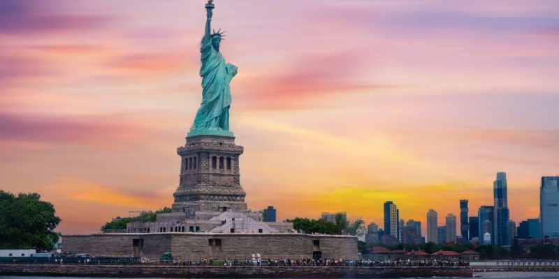 the statue of liberty in front of a new york skyline