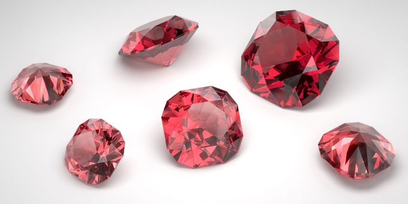 a collection of rubys on an off white background