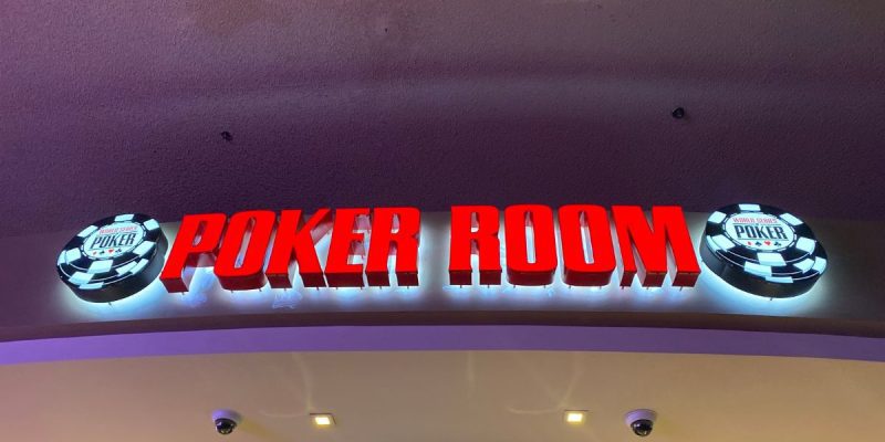 a world series of poke room sign hanging over the poker room in las vegas
