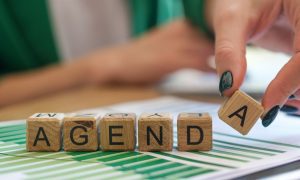 a set of blocks that spell out agenda on top of charts