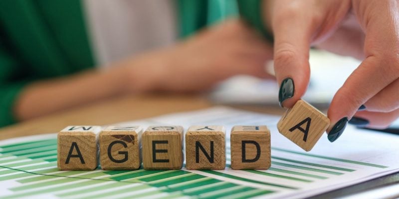 a set of blocks that spell out agenda on top of charts